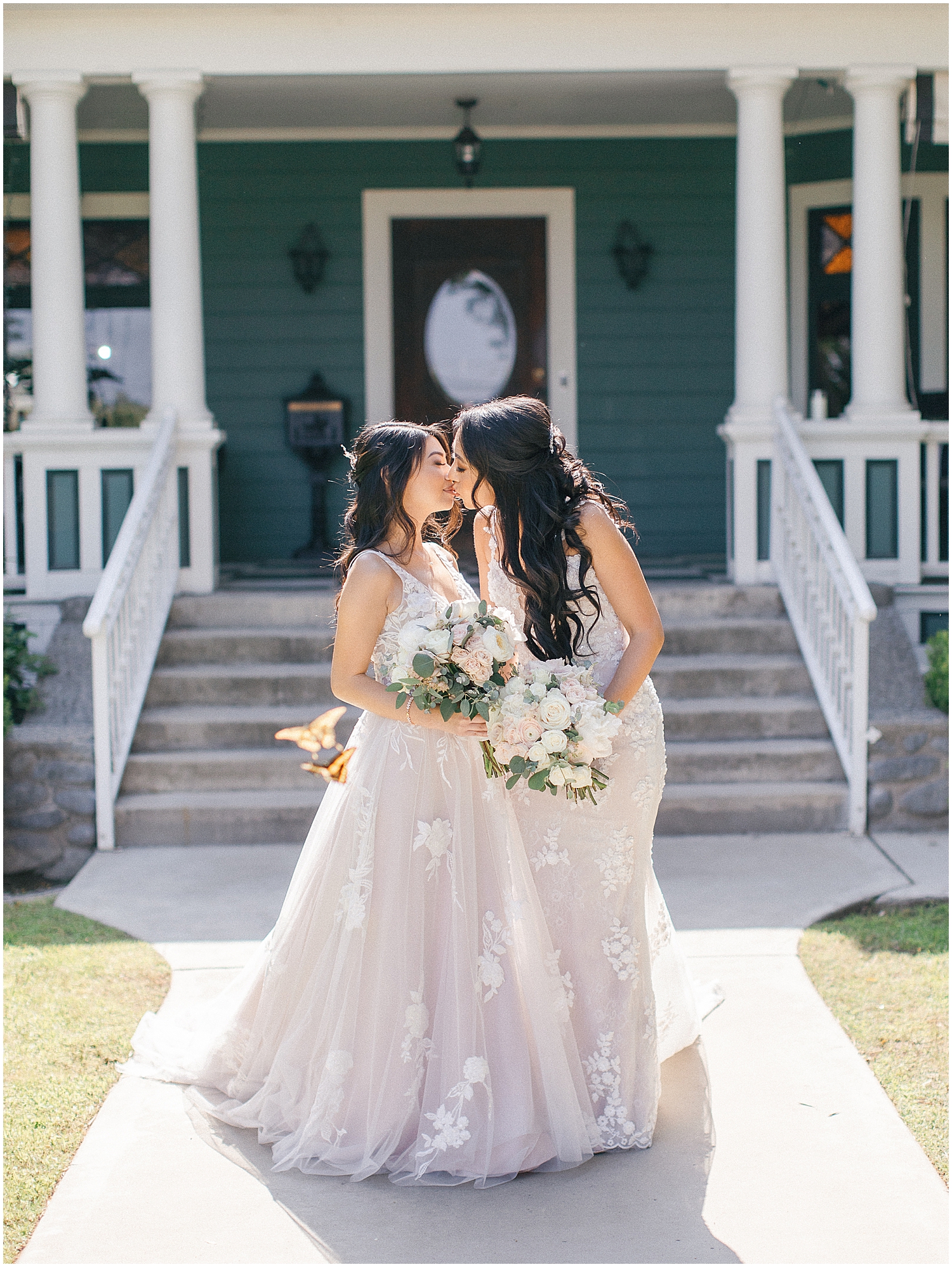 Brides share a joyful moment at their whimsical garden wedding in Southern California.