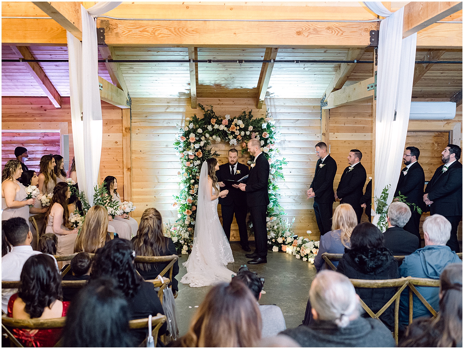 Elegant mountain wedding ceremony at Serendipity Garden with soft winter florals.