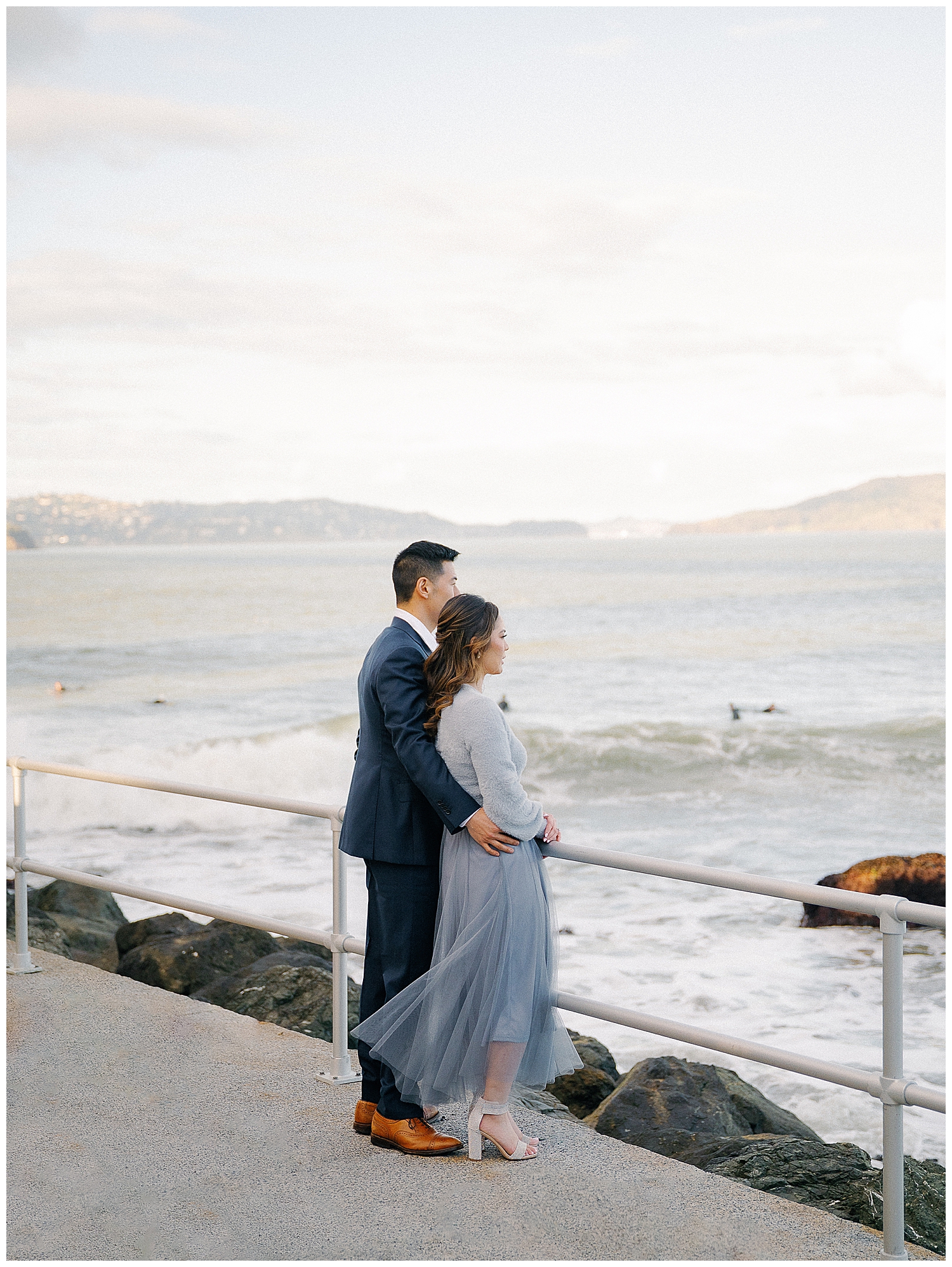 Romantic San Francisco engagement photo in front of the Golden Gate Bridge at Crissy Field.