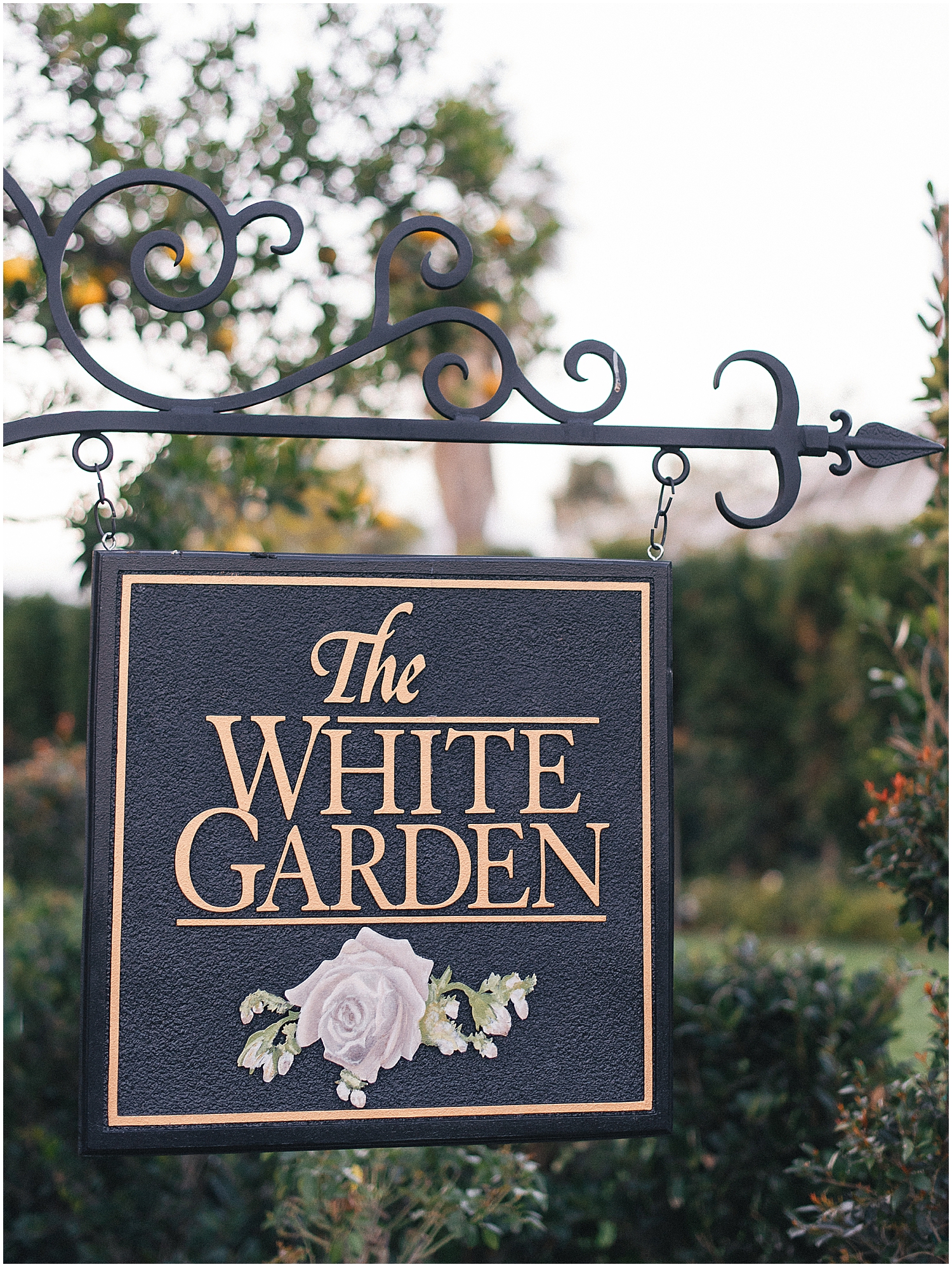 Brides exchanging vows in a lush garden setting at Christmas House Inn.