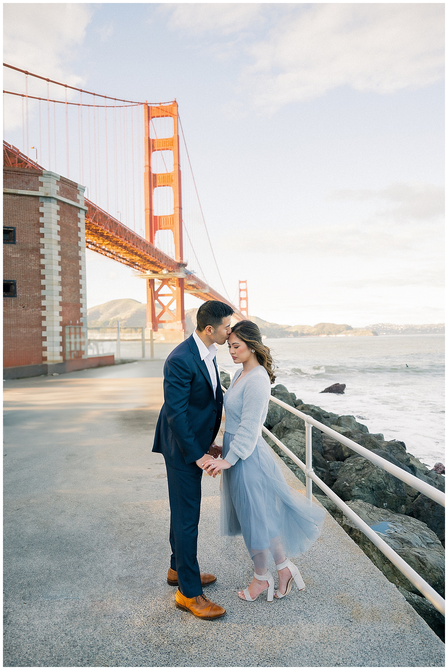 Romantic San Francisco engagement photo in front of the Golden Gate Bridge at Crissy Field.